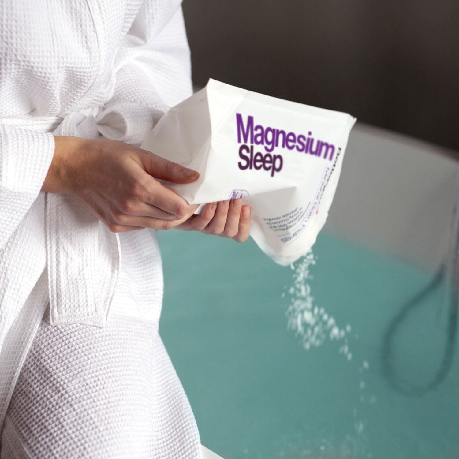 BetterYou Magnesium Sleep Mineral Bath Flakes being poured into a bath